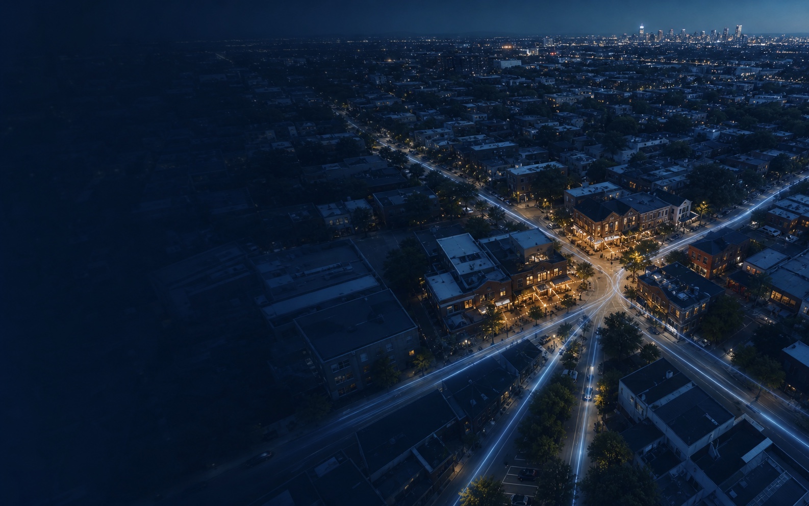An illuminated business district connected across a city at blue hour